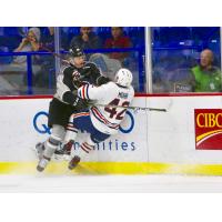 Vancouver Giants defenceman Ty Ettinger delivers a hit on the Kamloops Blazers