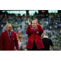 Sigi Schmid acknowledges the crowd at CenturyLink Field while donning his jacket from the National Soccer Hall of Fame on October 4, 2015