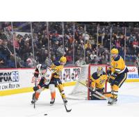 Flin Firebirds center Kyle Harris works behind the Erie Otters goal