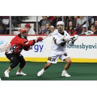 Logan Schuss of the Vancouver Warriors (right) vs. the Calgary Roughnecks