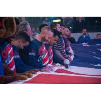 Kansas City Comets players hold the flag