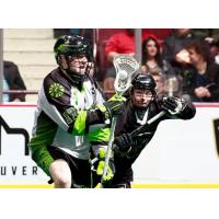 Saskatchewan Rush forward Robert Church (left) battles the Vancouver Warriors