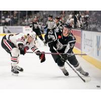 Bobby MacIntyre of the San Antonio Rampage (right) works down the boards against the Rockford IceHogs' Darren Raddysh