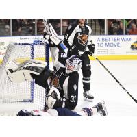 Utah Grizzlies goaltender Kevin Carr gets bowled over against the Tulsa Oilers