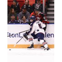 Vancouver Giants centre Justin Sourdif (right) against the boards vs. the Tri-City Americans