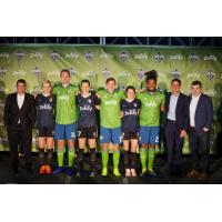 Sounders FC and Reign FC players wear their new Zulily-branded kits alongside team and Zulily leadership
