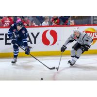 San Antonio Rampage captain Chris Butler (right) challenges Manitoba's Logan Stanley