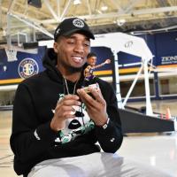 Donovan Mitchell admires his bobblehead