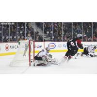 Prince George Cougars left win Tyson Upper scores against the Calgary Hitmen