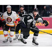 Tyler Wotherspoon of the San Antonio Rampage races for a puck with the Stockton Heat's Andrew Mangiapane