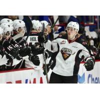 Vancouver Giants defenceman Bowen Byram receives congratulations from the bench