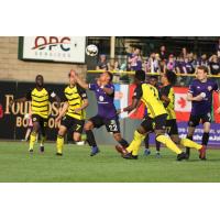 Louisville City FC midfielder George Davis IV (center) eyes a call vs. the Pittsburgh Riverhounds