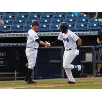 Kevin Mahoney (left) congratulates Dermis Garcia of the Tampa Tarpons after Garcia's homer