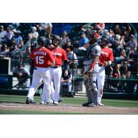 Jaycob Brugman of the Tacoma Rainiers receives congratulations after a home run