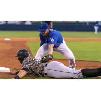 Connor Wong tags out a Travs runner at third in the Tulsa Drillers 6-1 victory over Arkansas