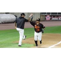 Ramon Cabrera of the Long Island Ducks gets a high five from Hector Sanchez as he rounds the bases