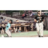 Milwaukee Milkmen catcher Christian Correa (right) walks away from the plate