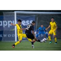 Aidan Daniels of Colorado Springs Switchbacks FC unleashes a shot against New Mexico United