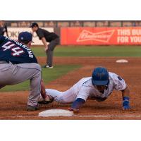 Romer Cuadrado of the Tulsa Drillers slides back safely into first on a pick off attempt
