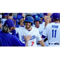 Hunter Feduccia is congratulated by Tulsa Drillers teammates after hitting a three-run home run