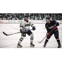 Eric MacAdams (left) skating for the University of New Hampshire