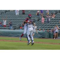 Alex Valdez of the Kansas City Monarchs leaps into the arms of teammate J.C. Escarra