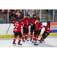 Rapid City Rush's Simon Lavigne celebrates win with teammates Max Coatta and Keanu Yamamoto