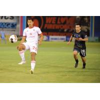 Phoenix Rising FC's Renzo Zambrano and Las Vegas Lights FC's Tyler Bagley on the field