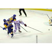 Saskatoon Blades' Ben Saunderson and Samuel Barcik battle Regina Pats' Hudson Kibblewhite