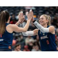 Grand Rapids Rise outside hitter Claire Chaussee (right) exchanges congratulations