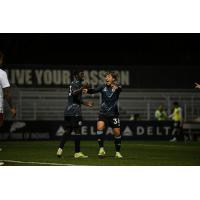 Tacoma Defiance's Georgi Minoungou and Yu Tsukanome celebrate win