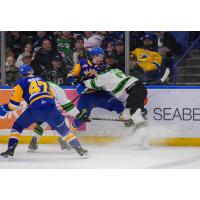 Saskatoon Blades' Charlie Wright and Prince Albert Raiders' Cole Peardon in action