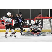 Wenatchee Wild forward Briley Wood looks to slip the puck past Kelowna Rockets goaltender Jari Kykkanen