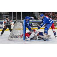 Wichita Thunder tries to poke the puck past the Allen Americans