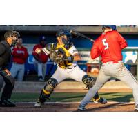 Charleston RiverDogs' Bryan Broecker and Kannapolis Cannon Ballers' Caden Connor in action