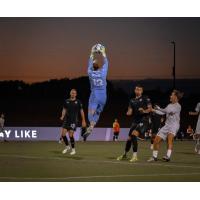 South Georgia Tormenta FC goalkeeper Drew Romig goes high to make a stop