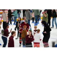 Tucson Roadrunners forward Cameron Hebig skates with fans