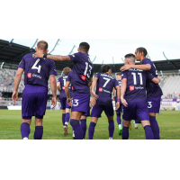 Louisville City FC exchanges congratulations following a goal