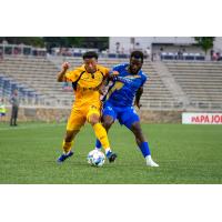 Rhode Island FC's Collin Smith battles Charlotte Independence's Fabrice Ngah