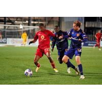 Phoenix Rising FC's Edgardo Rito versus Rhode Island FC's Jojea Kwizera and Clay Holstad