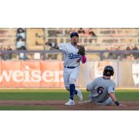 Tulsa Drillers' Yeiner Fernandez and Northwest Arkansas Naturals' Cayden Wallace in action