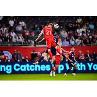 Chicago Fire FC's Fabian Herbers and New England Revolution's Matt Polster in action