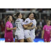 Racing Louisville midfielder Taylor Flint is congratulated by teammates following a goal