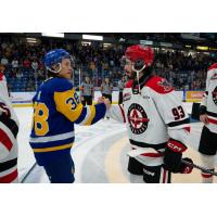 Saskatoon Blades' Trevor Wong congratulates Moose Jaw Warriors' Matthew Savoie