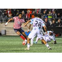 Atlético Ottawa's Luke Adam Singh and Pacific FC's Cédric Toussaint in action