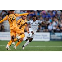 Colorado Springs Switchbacks FC's Ronaldo Damus battles the Rhode Island FC's Frank Nodarse