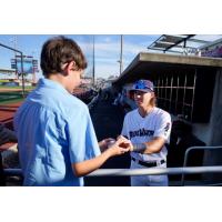 Pensacola Blue Wahoos' Harrison Spohn signs for a fan