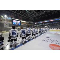 Wenatchee Wild players line up on the ice before the team's 2023-24 home opener