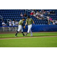 Biloxi Shuckers' Brock Wilken congratulated by teammate