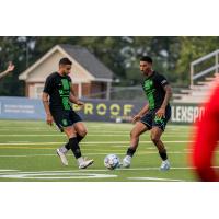 Lexington SC defender Modesto Mendez (44) kicks the ball while midfielder Abel Caputo (6) watches on